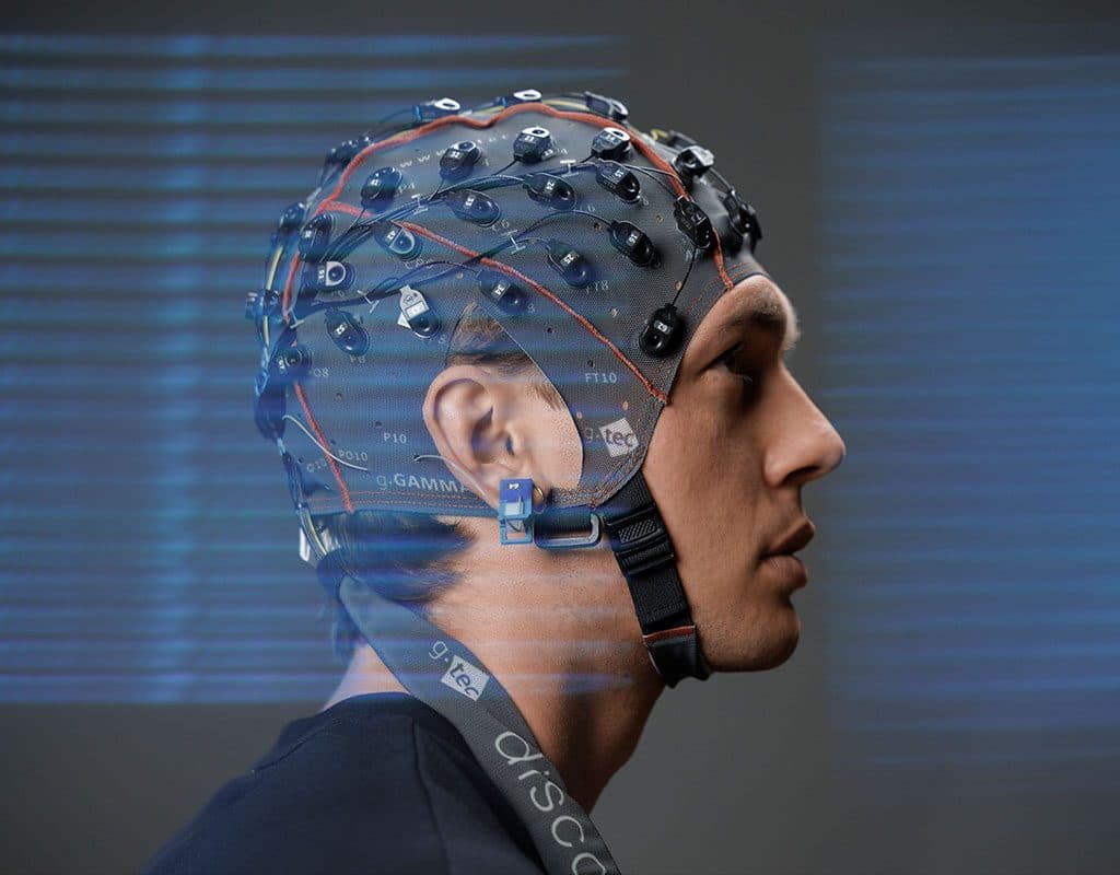 A participant wearing a g.GAMMAcap with active electrodes, in profile