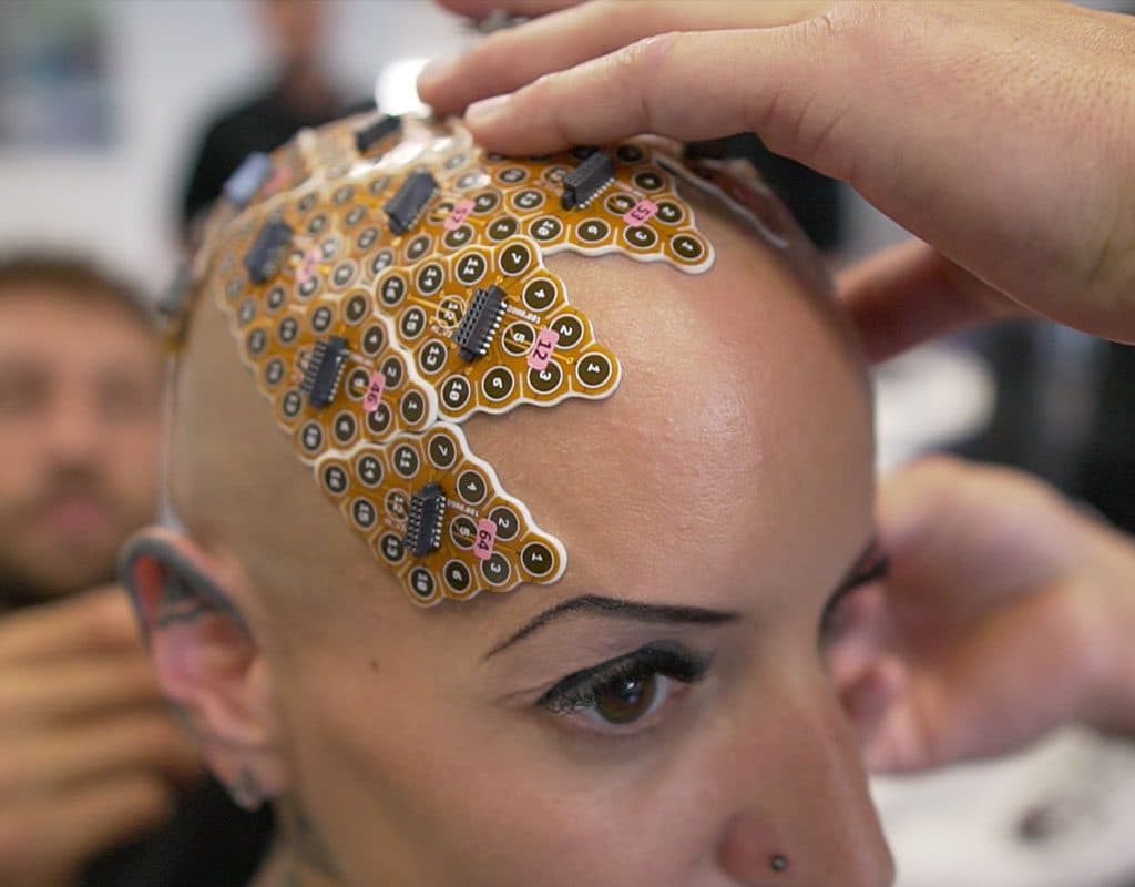 g.Pangolin electrode grids being placed on a participant's head