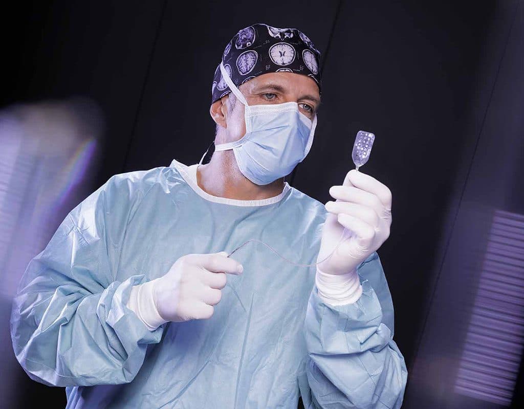 A surgeon holding an ECoG electrode strip