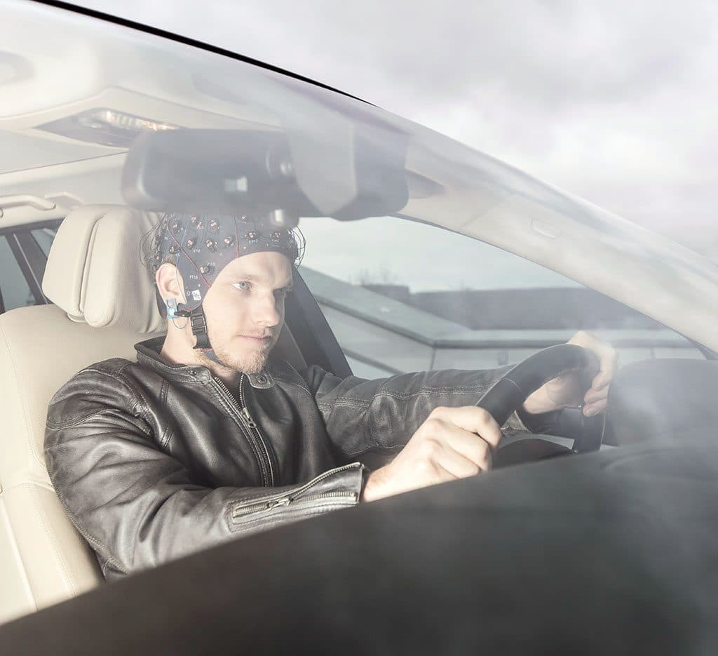 A participant driving a car in an EEG cap
