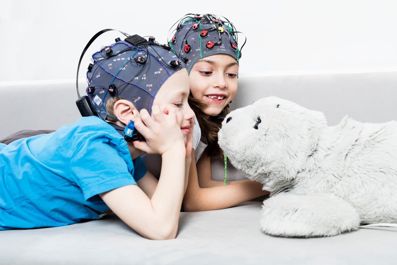 Children playing while wearing EEG caps