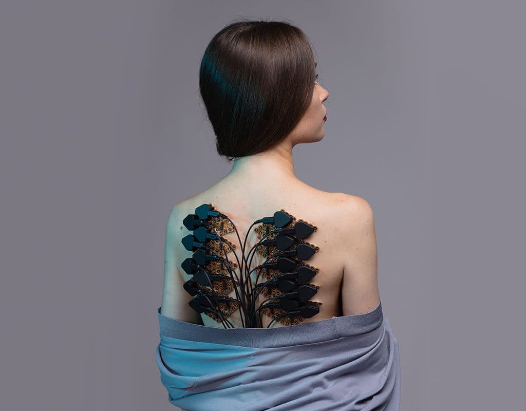 A woman with g.Pangolin grids and headstages on her back