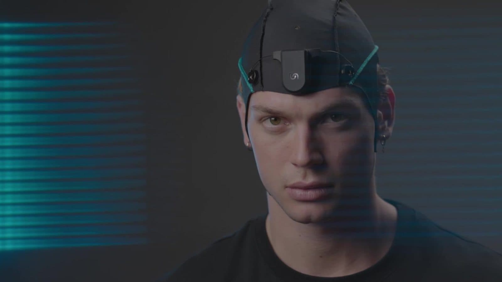 A young man with the Unicorn tDCS Core-2 stimulator on the front of his cap