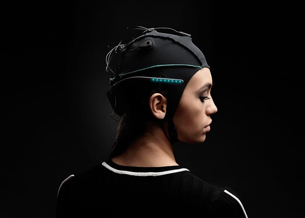 A woman wearing Unicorn Hybrid Black with the LED Bow, from the side