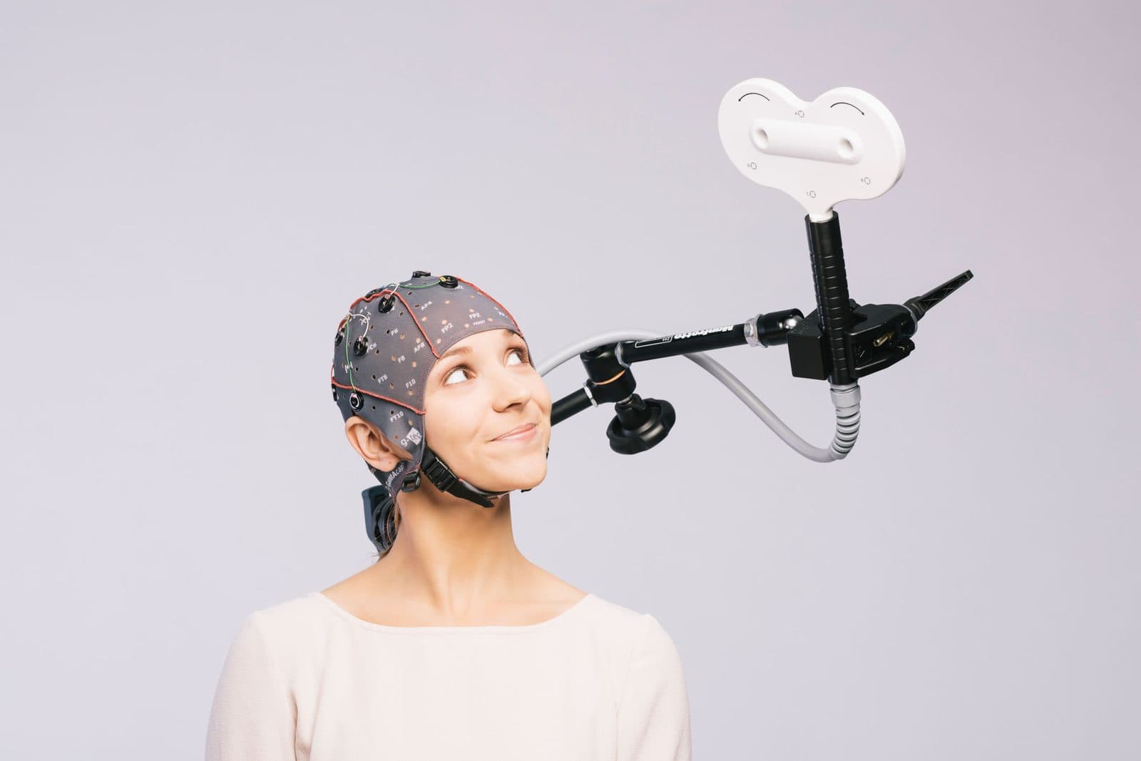 A TMS coil over an EEG cap