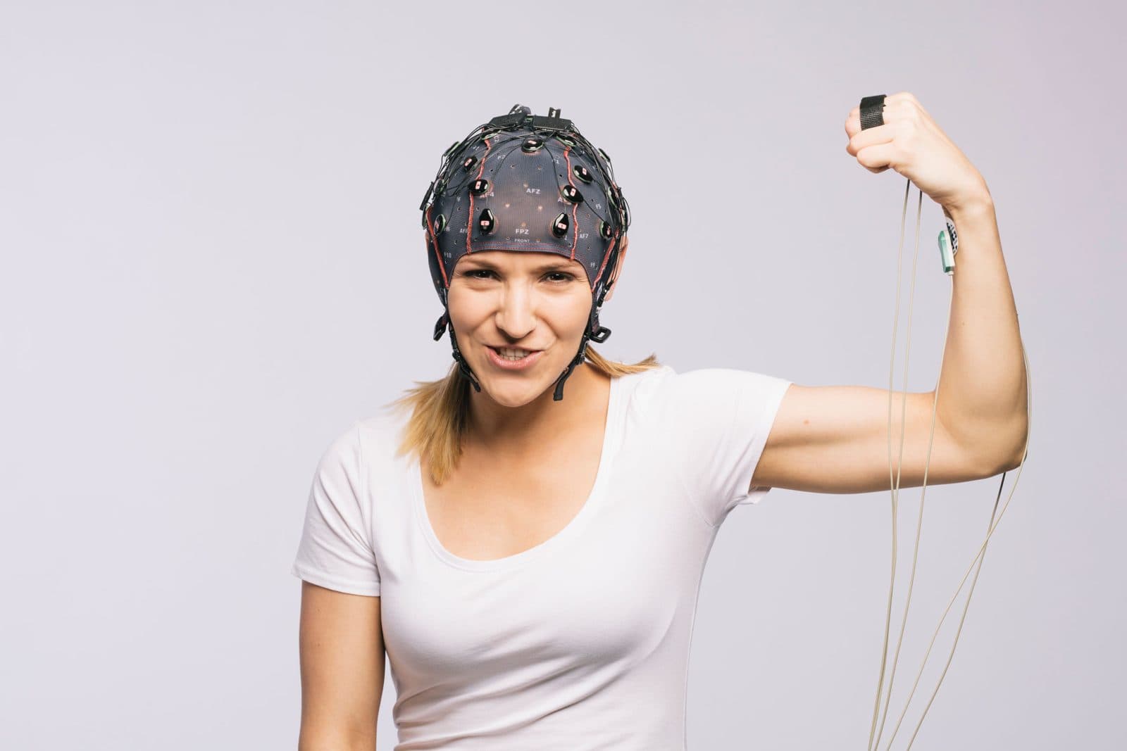 EEG başlığı ve kolunda biyosinyal sensörleri olan bir katılımcı
